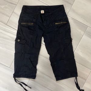 Black capris with exposed zipper detail